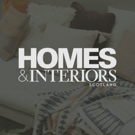 homes and interiors logo over an image of a sofa with cushions