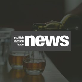 sltn logo over an image of whisky being poured into glasses