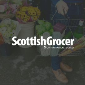 scottish grocer logo over an image of a person holding a shopping basket filled with groceries